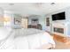 Spacious main bedroom featuring a fireplace, TV, and access to the ensuite bathroom at 12808 Harborwood Dr, Largo, FL 33774