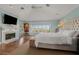 Bright main bedroom features a fireplace, sitting area, and large window with water views at 12808 Harborwood Dr, Largo, FL 33774