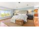This main bedroom has a window with natural light, an upholstered headboard and neutral colors at 12808 Harborwood Dr, Largo, FL 33774