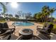 Beautiful pool area with a fire pit, lounge chairs, and lush tropical landscaping at 12808 Harborwood Dr, Largo, FL 33774