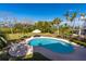 Relaxing backyard pool area with lush greenery and water views creating a private oasis at 12808 Harborwood Dr, Largo, FL 33774