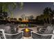 Relaxing backyard pool area with fire pit and tropical landscaping at 12808 Harborwood Dr, Largo, FL 33774