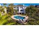 Aerial view of a private pool with an expansive patio and lush landscaping at 12808 Harborwood Dr, Largo, FL 33774