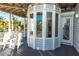 Covered porch with chairs, a view of the yard, and an enclosed sunroom at 12808 Harborwood Dr, Largo, FL 33774