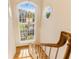 Bright stairway with a large arched window and decorative hanging light fixture at 12808 Harborwood Dr, Largo, FL 33774