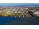 An aerial view showcasing the waterfront property, private dock, outlined property lines, and location at 12808 Harborwood Dr, Largo, FL 33774
