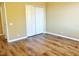 Empty bedroom with bi-fold closet and wood floors at 12847 Darby Ridge Dr, Tampa, FL 33624