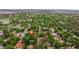 An aerial shot shows a neighborhood with green trees, quaint homes, and a clear view of the horizon at 1301 45Th N Ave, St Petersburg, FL 33703