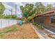Backyard with a white fence, walkway, playset, and view of the screened patio at 1301 45Th N Ave, St Petersburg, FL 33703