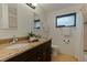 Bathroom with double sinks, granite countertop, and shower-tub combo at 1301 45Th N Ave, St Petersburg, FL 33703