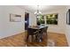 Inviting dining room with wood floors and a chandelier, next to a large window at 1301 45Th N Ave, St Petersburg, FL 33703