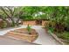 Charming home featuring a unique facade, a well-manicured lawn, and mature trees at 1301 45Th N Ave, St Petersburg, FL 33703