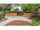 Charming home featuring a unique facade, a well-manicured lawn, and mature trees at 1301 45Th N Ave, St Petersburg, FL 33703