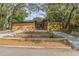 Charming home exterior with unique architectural details, landscaping, and a circular driveway enhancing its appeal at 1301 45Th N Ave, St Petersburg, FL 33703