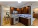 Well-lit kitchen featuring dark cabinets, granite countertops, and stainless steel appliances at 1301 45Th N Ave, St Petersburg, FL 33703