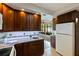 Kitchen featuring granite countertops, dark wood cabinets, and stainless steel appliances at 1301 45Th N Ave, St Petersburg, FL 33703