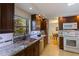 Well-lit kitchen featuring dark cabinets, granite countertops, and stainless steel appliances at 1301 45Th N Ave, St Petersburg, FL 33703