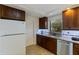 Cozy kitchen featuring dark wood cabinetry, granite countertops, and stainless steel appliances at 1301 45Th N Ave, St Petersburg, FL 33703