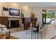 Cozy living area with hardwood floors, stone fireplace, a TV, and sliding glass doors to the back patio at 1301 45Th N Ave, St Petersburg, FL 33703