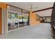 Open patio with sliding glass doors and ceiling fans overlooking the backyard at 1301 45Th N Ave, St Petersburg, FL 33703