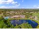 Breathtaking aerial view of the community with a clubhouse, pool, lake, and a golf course at 1319 Leland Dr # 101, Sun City Center, FL 33573