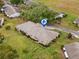 Aerial view of a single Gathering home with mature trees and landscaping at 1319 Leland Dr # 101, Sun City Center, FL 33573