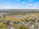 Scenic aerial view of a community with a golf course, ponds, and single-story homes on well-maintained lawns at 1319 Leland Dr # 101, Sun City Center, FL 33573