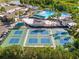 Aerial view of the community featuring Pickle Ball courts, pool and clubhouse in a tropical setting at 1319 Leland Dr # 101, Sun City Center, FL 33573