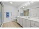 Bathroom features all white decor, a spacious vanity, and walk-in shower at 1319 Leland Dr # 101, Sun City Center, FL 33573