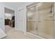 Bathroom showcasing the glass shower and view into the bedroom at 1319 Leland Dr # 101, Sun City Center, FL 33573