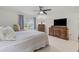 Bright bedroom with a ceiling fan, large dresser, and a window providing natural light at 1319 Leland Dr # 101, Sun City Center, FL 33573