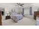 A bright bedroom featuring a large window with natural light, ceiling fan, and comfortable decor at 1319 Leland Dr # 101, Sun City Center, FL 33573