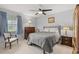 Comfortable bedroom with ceiling fan, wood furniture, and picture window at 1319 Leland Dr # 101, Sun City Center, FL 33573