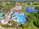 Overhead view showcasing a spacious community pool area, perfect for relaxation and recreation with mature landscaping at 1319 Leland Dr # 101, Sun City Center, FL 33573