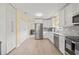 Well-equipped kitchen with stainless steel appliances, white cabinetry, and ample storage at 1319 Leland Dr # 101, Sun City Center, FL 33573