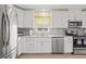Modern kitchen featuring white cabinets, stainless appliances, and granite countertops at 1319 Leland Dr # 101, Sun City Center, FL 33573