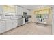 Updated kitchen with white cabinetry, stainless steel appliances, and sunny window at 1319 Leland Dr # 101, Sun City Center, FL 33573