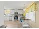 Bright kitchen features white cabinets, stainless steel appliances, and a charming island with wood countertop at 1319 Leland Dr # 101, Sun City Center, FL 33573