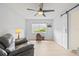 Cozy living room with a comfortable recliner, lots of light, and sliding barn door at 1319 Leland Dr # 101, Sun City Center, FL 33573
