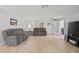 Open-concept living room featuring luxury vinyl floors, neutral walls, and natural light at 1319 Leland Dr # 101, Sun City Center, FL 33573