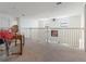 Bright upstairs loft with neutral carpet and light fixtures featuring a unique design at 15041 Sea Salt Way, Bradenton, FL 34211