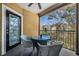 Relaxing balcony with outdoor seating, offering a pleasant view of the neighborhood and blue sky at 1810 E Palm Ave # 4304, Tampa, FL 33605