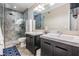 Well-lit bathroom with dual sinks, granite counters, and a tiled walk-in shower at 1810 E Palm Ave # 4304, Tampa, FL 33605