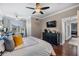 Spacious bedroom featuring a ceiling fan, TV, and dark dresser for ample storage at 1810 E Palm Ave # 4304, Tampa, FL 33605