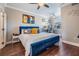 Comfortable bedroom with a blue velvet bed, ceiling fan, and a dedicated workspace at 1810 E Palm Ave # 4304, Tampa, FL 33605
