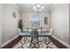 A bright dining room featuring a glass table, four chairs, and modern chandelier at 1810 E Palm Ave # 4304, Tampa, FL 33605