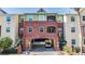 Multi-level residential building with gated drive-through, brick facade, and well-maintained landscaping at 1810 E Palm Ave # 4304, Tampa, FL 33605
