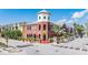 A striking corner building with multi-level brickwork, a tower feature, and vibrant signage at 1810 E Palm Ave # 4304, Tampa, FL 33605