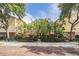 Beautiful view of residential building with brick-paved street, mature trees, and manicured hedges at 1810 E Palm Ave # 4304, Tampa, FL 33605