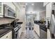 Bright, updated kitchen with stainless steel appliances, granite counters, and adjoining dining area at 1810 E Palm Ave # 4304, Tampa, FL 33605